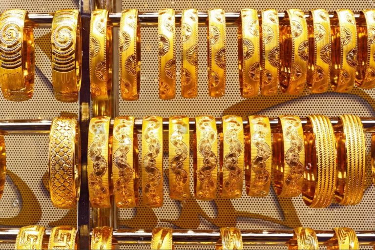 Rows of patterned gold bangles displayed at a Dubai jewelry shop